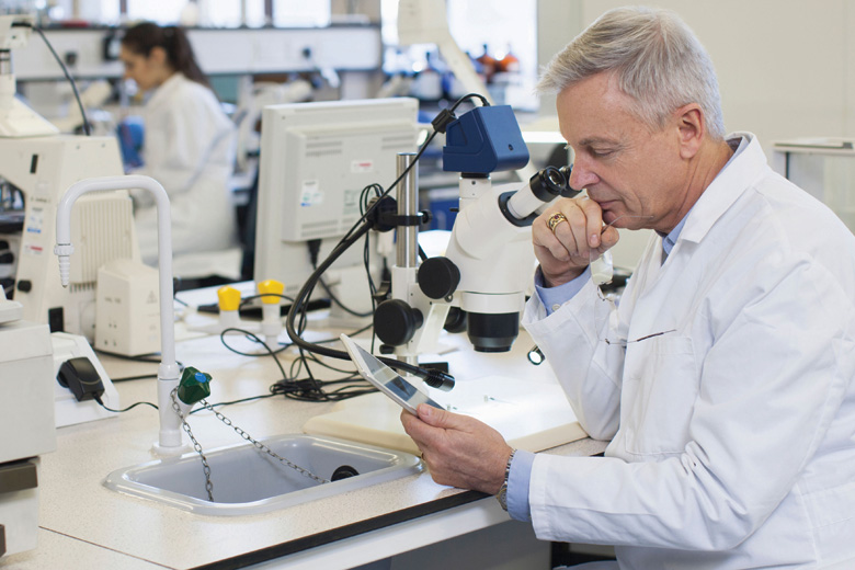 male-scientist-using-tablet-computer-in-laboratory